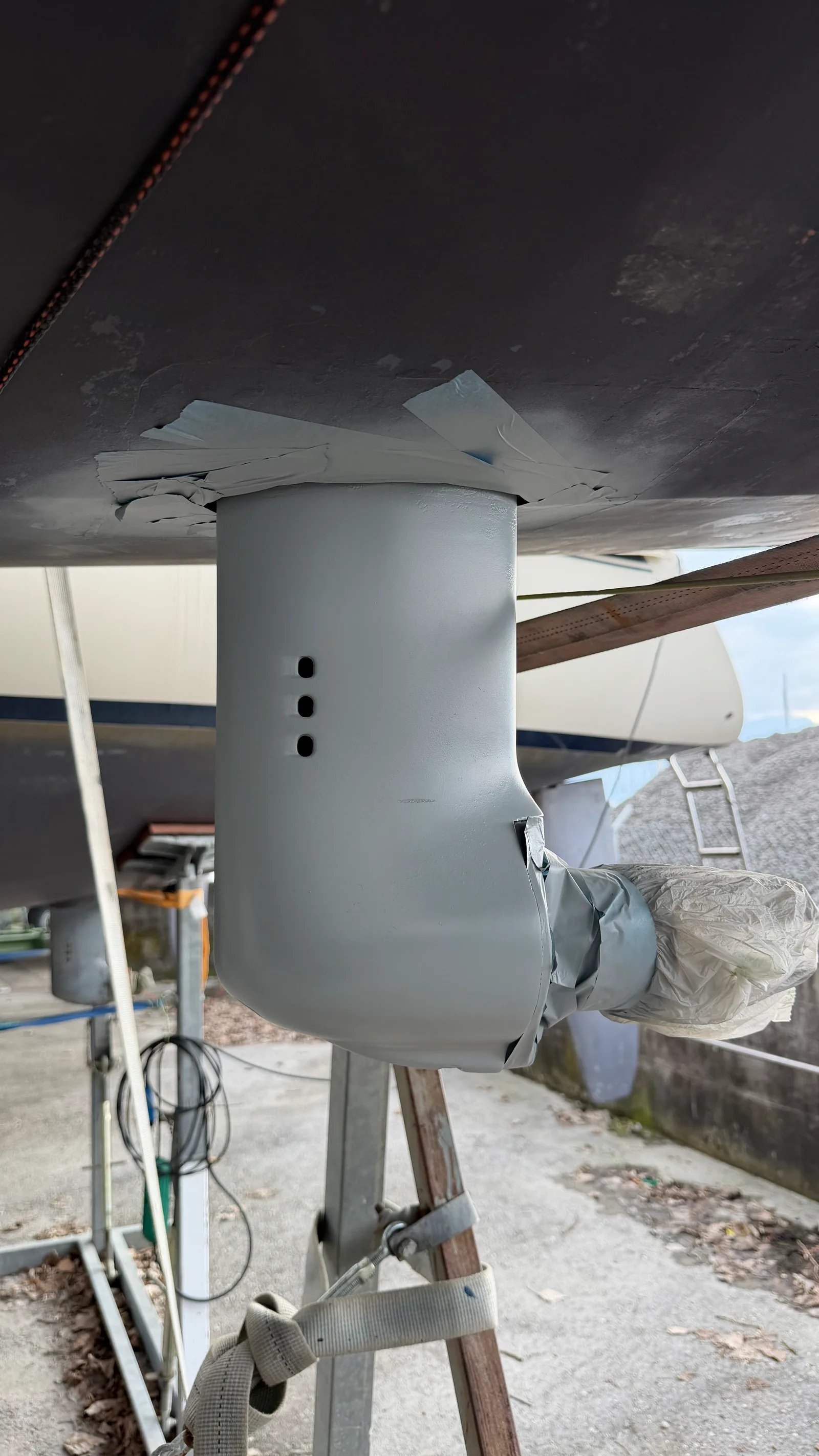 Sail Drive leg with the grey Volvo antifouling spray applied in coats, prop shaft opening still masked