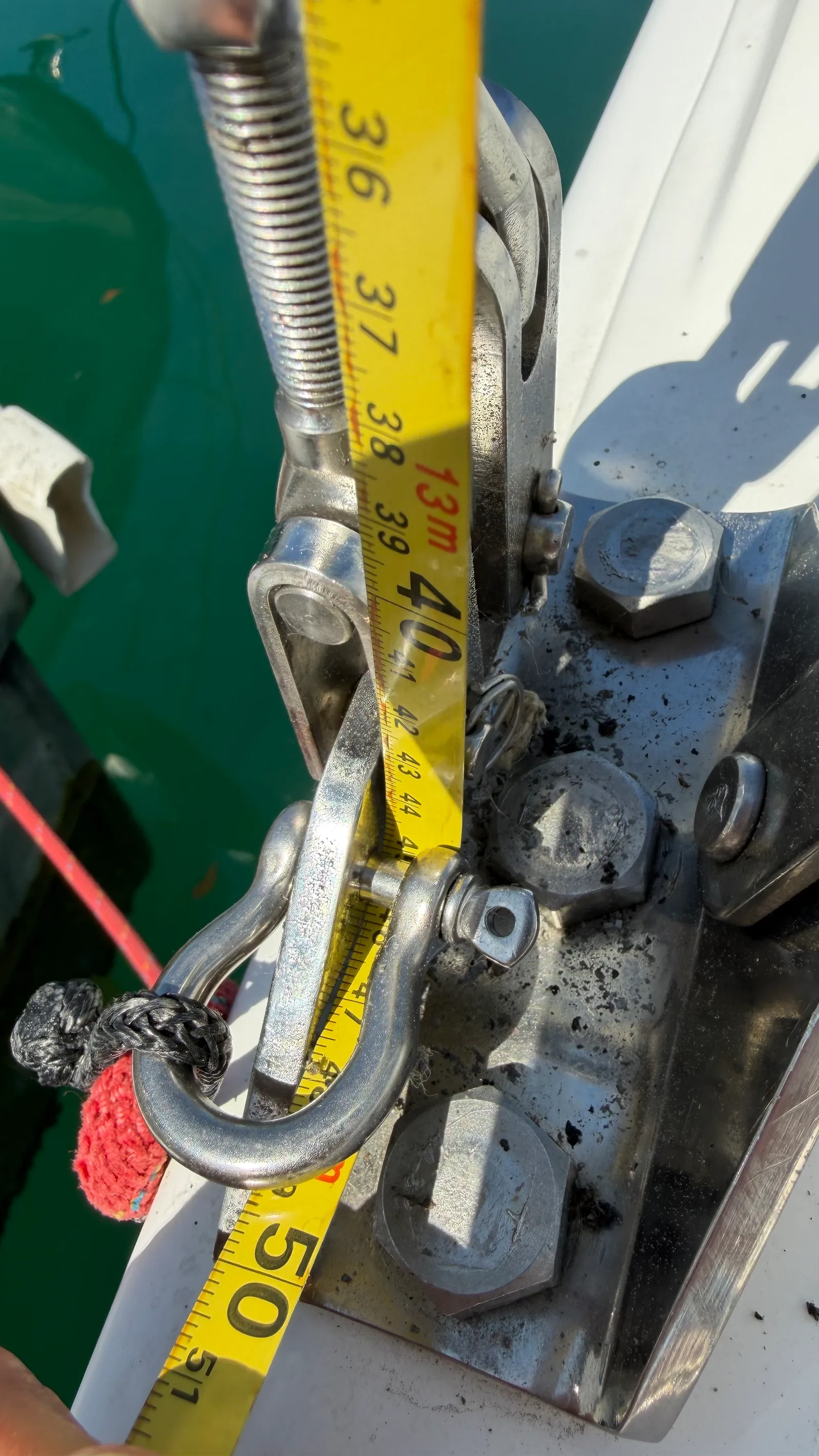 Centring — port reading: tape run from the same halyard down to the port chainplate; when starboard and port match, the masthead is centred