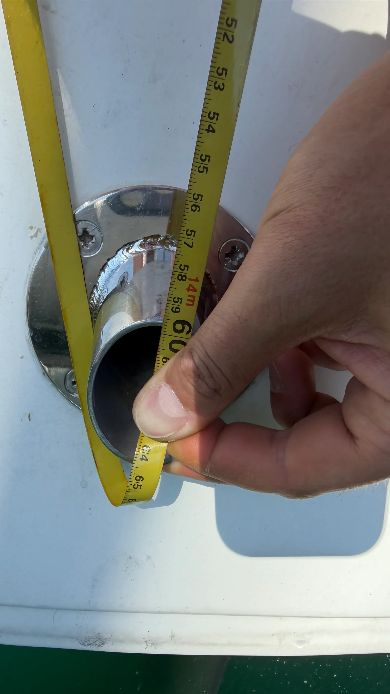 Aft-rake check: tape run from a halyard down to an aft reference point on JAMAIS