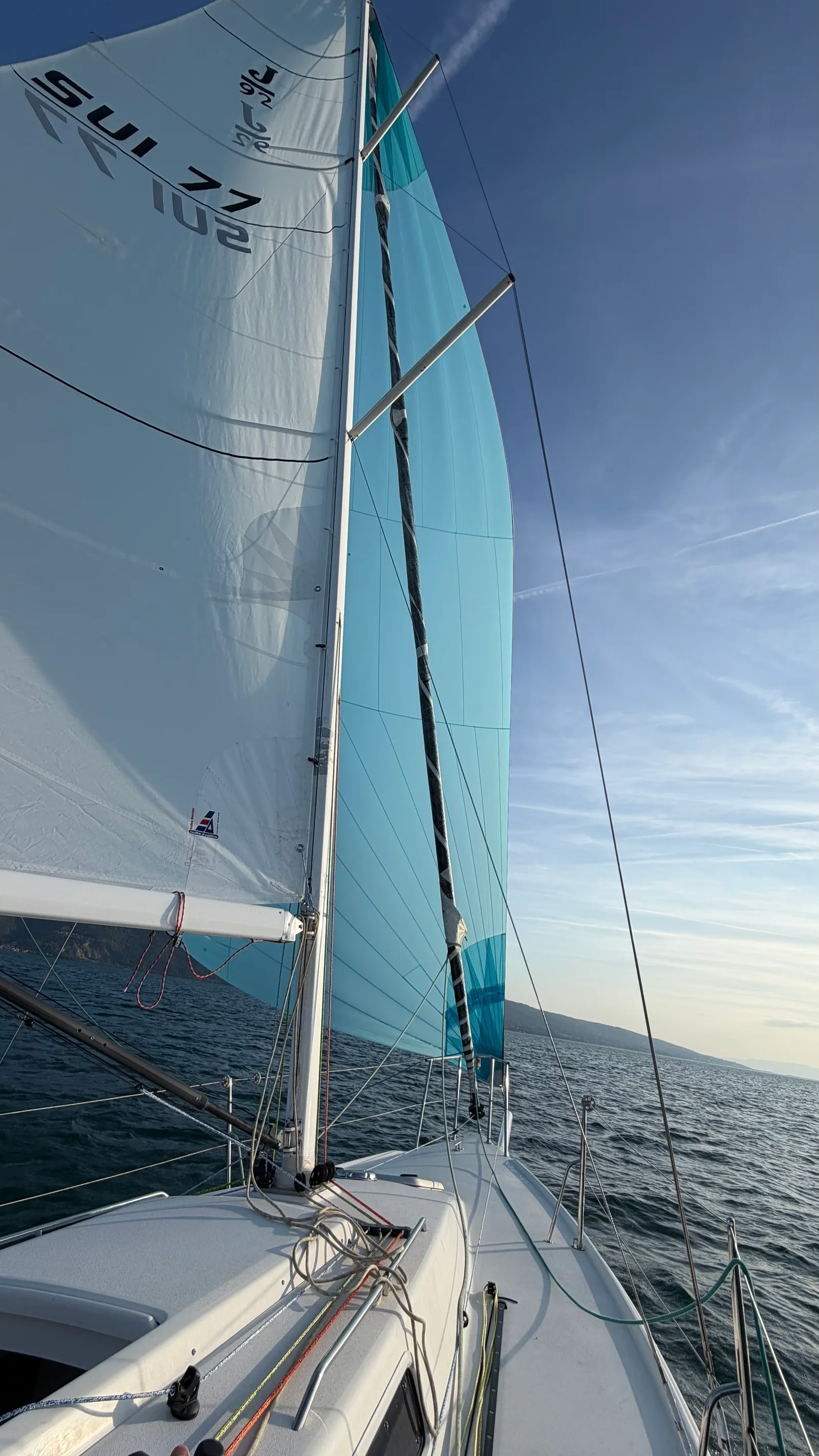 Blue gennaker hoisted on JAMAIS, orange Marlow D2 Racing 8 mm halyard under load, seen from the cockpit