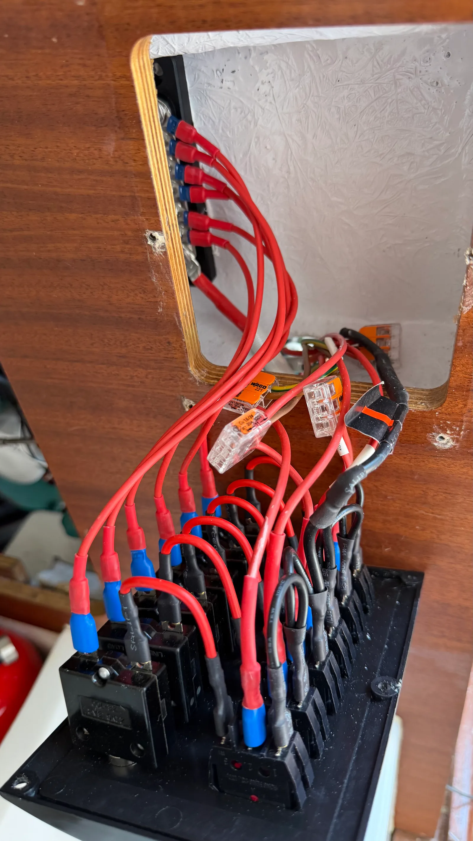 Back of the 12V panel with the six Zing Ear and Kuoyuh breakers wired, dedicated feed per channel, WAGO 221 lever nuts for the taps